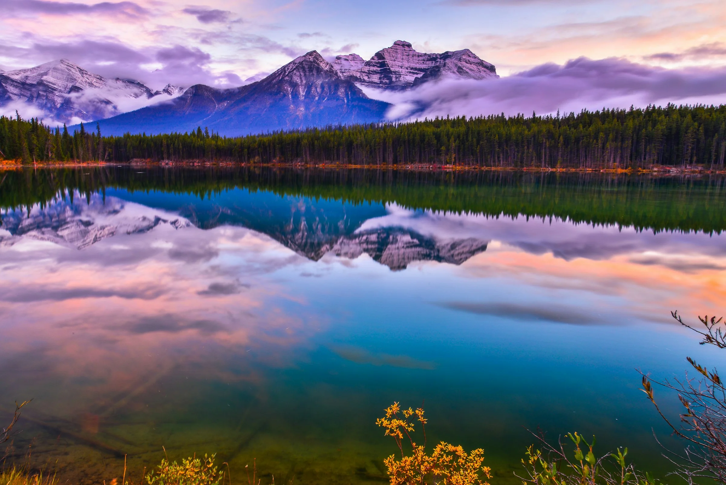 Alberta’s Rocky Mountains reflected in a calm lake in Banff National Park
